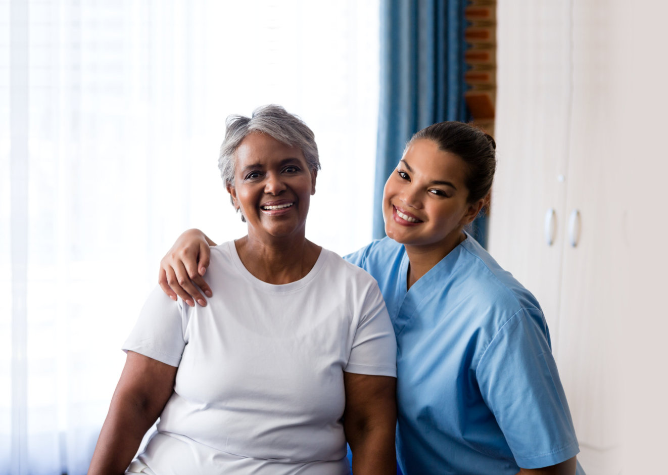 senior woman with her caregiver smiling