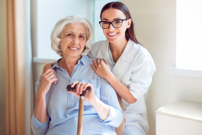 smiling and cheerful senior woman with her kind nurse